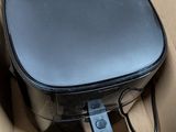a black suitcase in a cardboard box on the floor