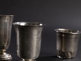 three silver cups sitting next to each other on a table