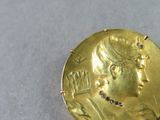 an image of a close up of a gold coin on a table