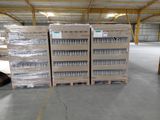 several pallets of bottled water are stacked on pallets in a warehouse