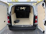 a white van with the back door open and a dog crate in the back
