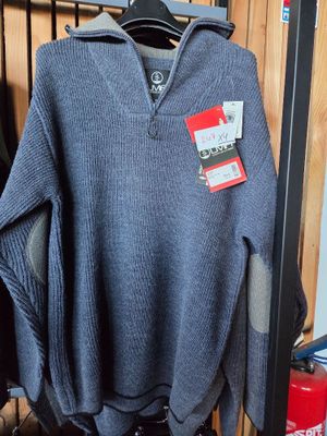 a sweater hanging on a rack in a store
