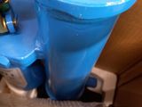 a blue trash can sitting on top of a cardboard box