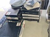 a lot of books on a table with a lamp on it