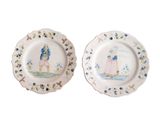 two plates with a painting of a man and a woman on them