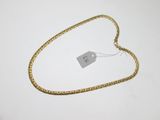a close up of a gold chain with a price tag on it