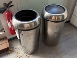 two trash cans sitting next to each other on the floor