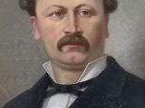portrait of a man with a mustache in a suit and bow tie