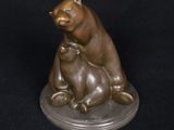 bronze sculpture of a bear and cub sitting on a base