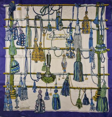a blue and white scarf with a bunch of tassels on it