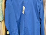 a blue shirt hanging on a rack in a store