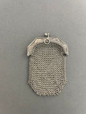 a silver metal mesh purse with a chain around it