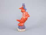 figurine of a red and blue bird on a white pedestal