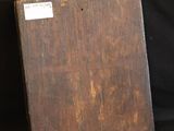 a wooden block with a label on it on a black background