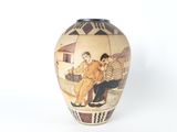 a vase with a picture of a man and a woman sitting on a bench