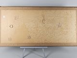 an open box with a drawing on it sitting on top of a metal stand