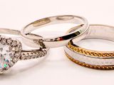 three wedding rings with diamonds on a white background