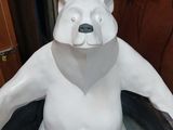 a statue of a polar bear that is sitting in a tub