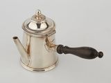 an antique silver coffee pot with a wooden handle on a white surface