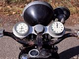 a close up of a motorcycle with a clock on the handlebars