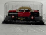 a red and yellow car in a glass case