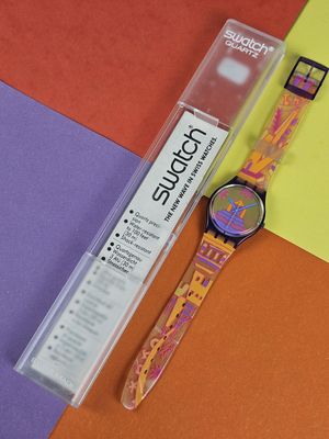 a watch that is sitting on a colorful surface