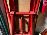 a red fire hydrant sitting next to a cardboard box