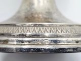 a close up of a silver plate on a table