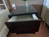 a vase of flowers sitting on top of a nightstand