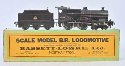 a black and yellow model of a train on a green box