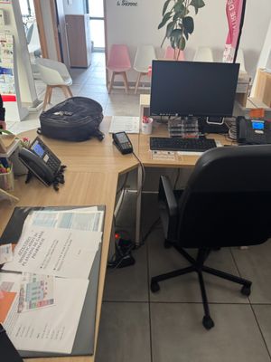 a desk with a computer and a phone on it
