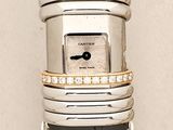 a silver and black ring on top of a piece of wood