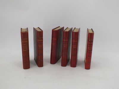 five red books are lined up in a row on a white surface