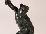 an image of a bronze statue of a man holding a spear