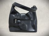 black leather purse with zippers on a white background