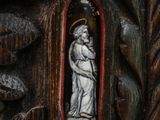 carvings of a woman holding a child in a carved wood frame
