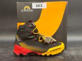 the black and yellow shoe is next to a box of money