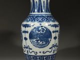 a blue and white vase with a bird on it