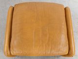 a brown leather chair with a foot rest and foot rest