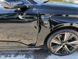 a black car that is parked on the side of the road