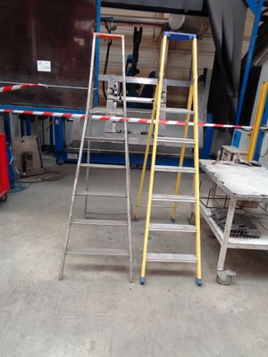 two ladders that are sitting in a garage