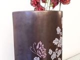 a vase with flowers in it sitting on a table