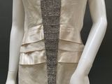 an image of a mannequin wearing a beige dress with a black and white design