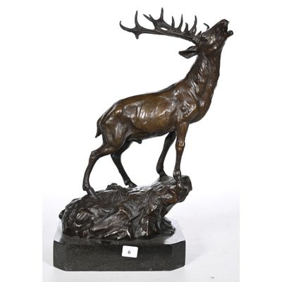 an image of a bronze statue of a stag on a rock