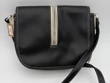 a black leather cross body bag with a silver zipper
