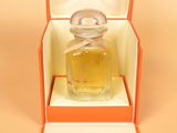 perfume bottle in an orange box on a beige background