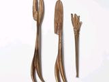three wooden spoons and a fork on a white background