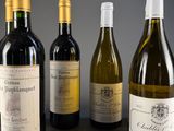 several bottles of wine are lined up on a table