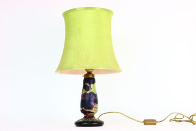 une lampe surmontée d'un abat-jour vert