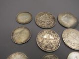 several different types of coins are arranged on a table